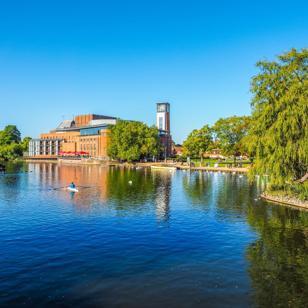 The River Avon and the Royal Shakespeare Theatre in Stratford-upon-Avon on a clear day