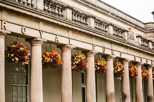 The colonnade of the Royal Pump Rooms in Warwickshire, dressed with autumn hanging baskets